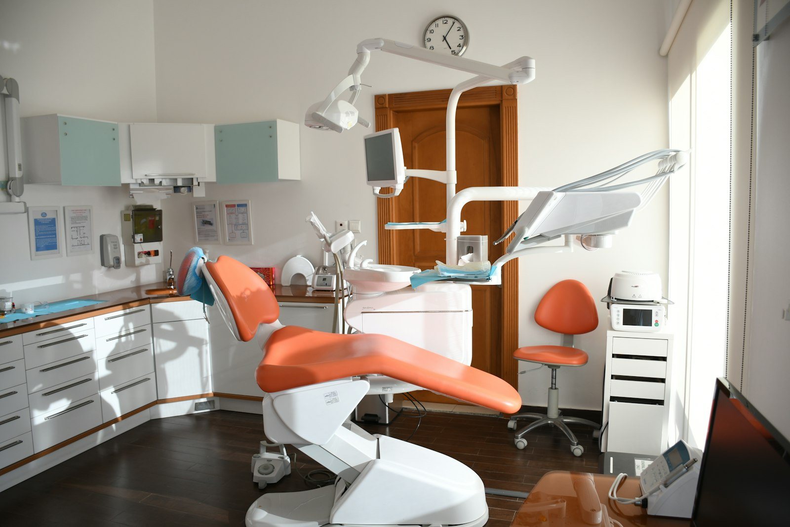 A calm patient relaxing in the dental chair with a reassuring clinician nearby
